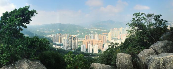 Panoramic view of trees and mountains against sky