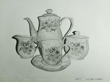 Close-up of carving on table against wall