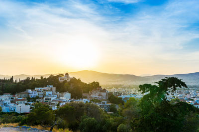 Scenic view of town against sky at sunset