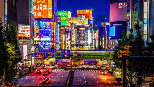 Illuminated city street and buildings at night,tokyo,japan