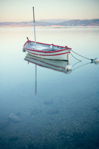 Fishing boat in sea against sky