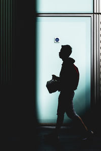 Side view of man holding umbrella