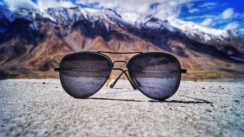 Close-up of sunglasses on land