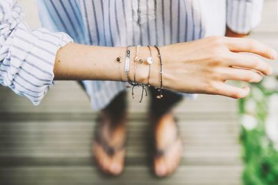 Low section of teenage girl showing bracelets