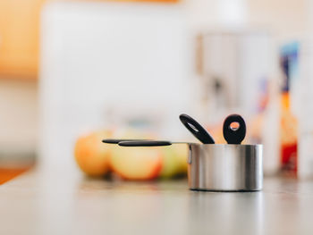 Apples and measuring cups on kitchen counter 