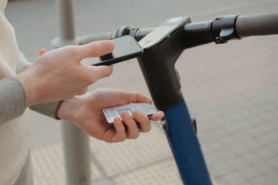 Cropped hands of man repairing bicycle