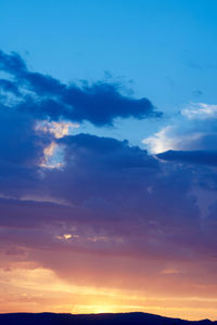 Low angle view of dramatic sky during sunset