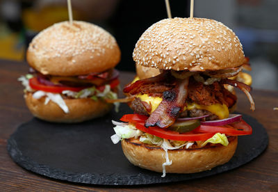 Close-up of hamburgers on slate over table