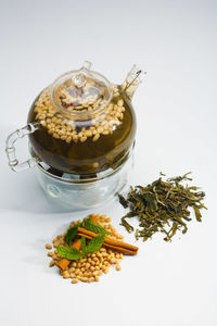 Close-up of tea in jar against white background