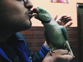 Midsection of man eating bird