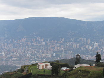 Buildings in city against cloudy sky