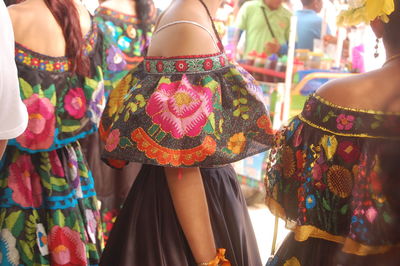 Midsection of women standing in traditional clothing