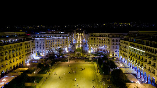 High angle view of city lit up at night