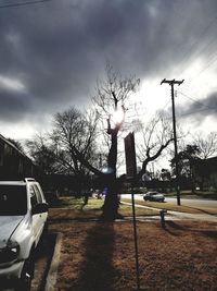 Cars on road against sky in city