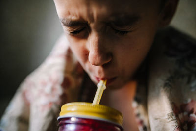 Close-up of boy drinking juice