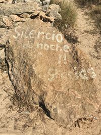 High angle view of text on rock