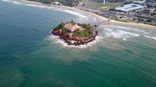 High angle view of sea and buildings in city