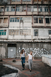 Woman standing by building in city