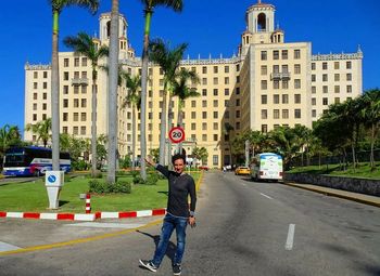 Man on road against buildings in city