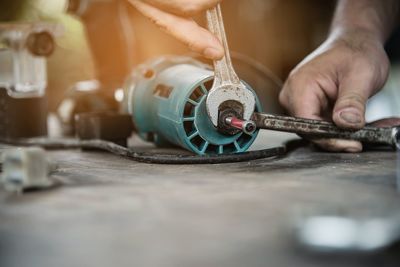 Close-up of man working on metal