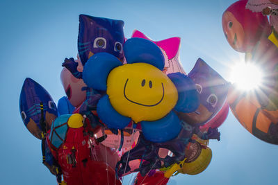 Low angle view of balloons against sky