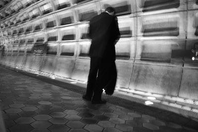 Rear view of woman standing at subway station