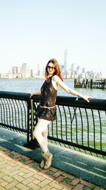 Woman sitting on bench in city