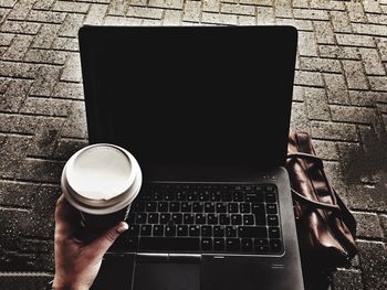 Midsection of man holding mobile phone