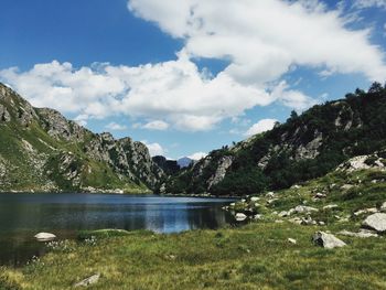 Scenic view of lake and mountains against sky