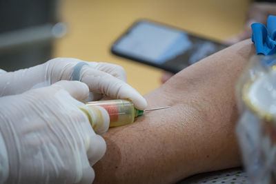 Close-up of human hand holding camera