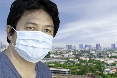 Portrait of man with city in background