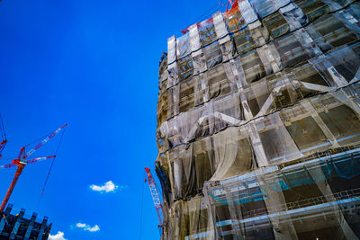 Low angle view of modern building against clear blue sky