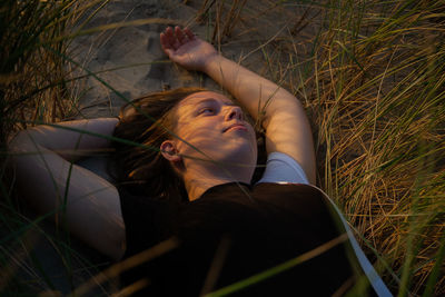 Woman lying down on field