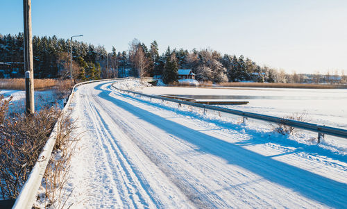 Snow covered landscape against clear sky