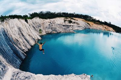 Scenic view of person jumping into water