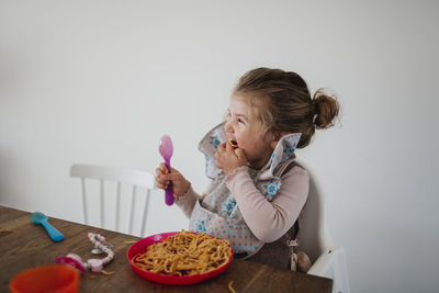 Girl eating spaghetti