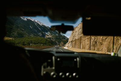 Cars on road against mountain range