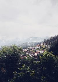 High angle view of trees and buildings against sky