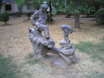 Statue against trees