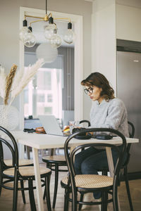 Woman at table working at home