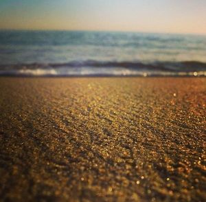 Close-up of sand on beach against sky