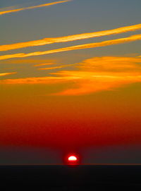 Scenic view of sea against romantic sky at sunset