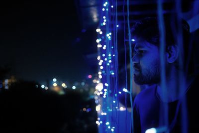 Portrait of woman looking away at night