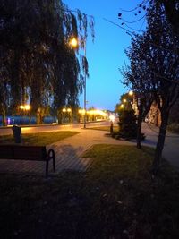 Illuminated street light against sky at night