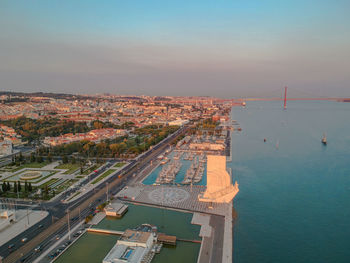 High angle view of buildings by sea against sky