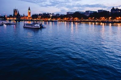 Boats in river with buildings in background