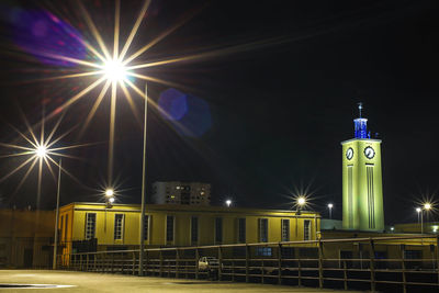 Illuminated city street at night