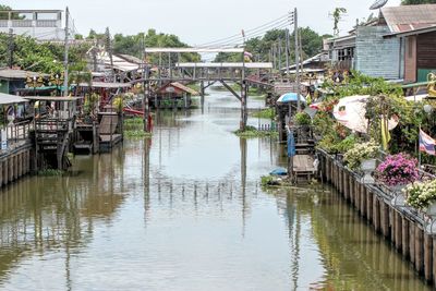 Bridge over canal amidst buildings in city