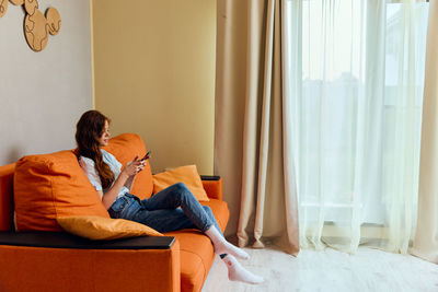 Young woman using digital tablet at home