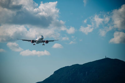 Low angle view of airplane flying against sky